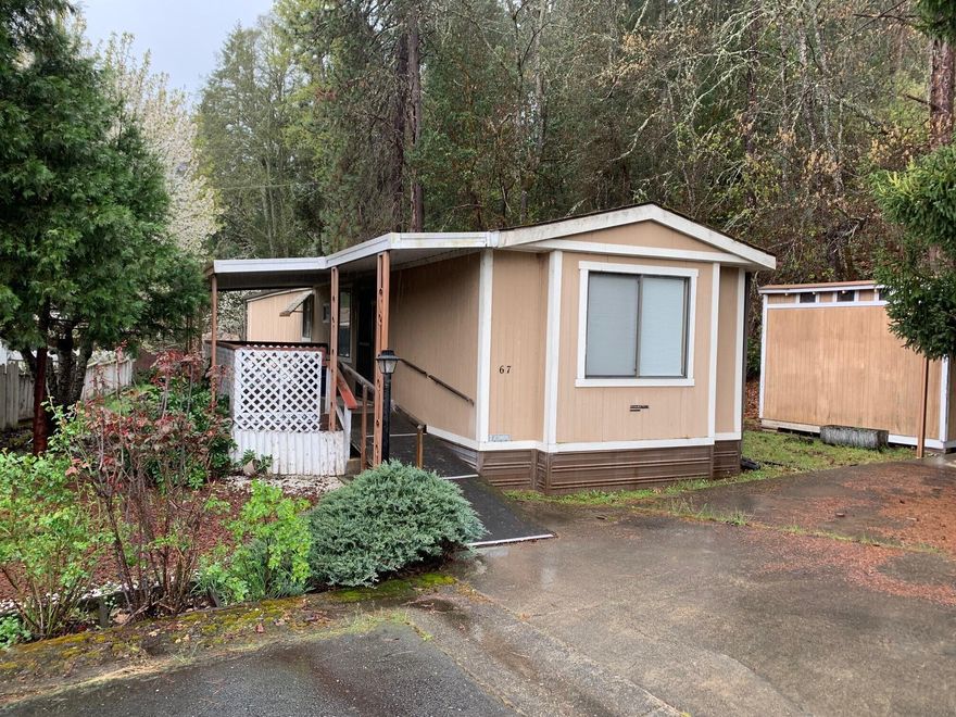 You will enjoy the private setting at the end of a quiet street where this 2 bedroom, 2 bath, single-wide is set up. 
 Vaulted ceilings, central air and heat, primary bedroom and bath includes a garden tub and separate shower.  Covered deck in front to enjoy the peaceful setting.  Carport and storage shed included.  Located in a senior park at the edge of the town of Rogue River. 
 Home needs a little attention, but priced with your own improvements in mind.