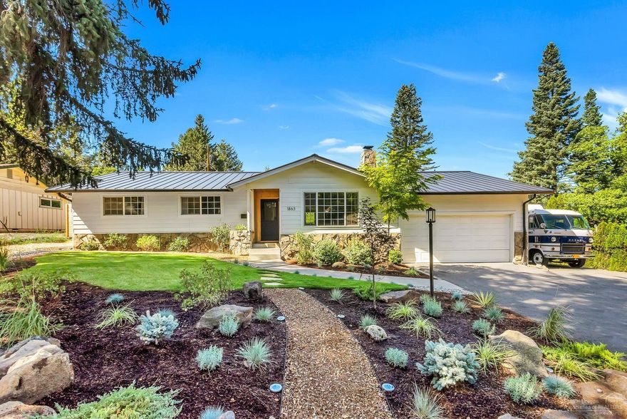 Nestled on a quiet, dead end street and perched above Hollinshead Park, this soulful ranch house personifies all that's great about Mid Town living. This corner lot is spacious and private, boasting a stylish entertainers backyard with plenty of space to play! Step inside, which has been tastefully remodeled with too many upgrades to list. The space is anchored by a designer's kitchen which includes all new cabinetry, quartz counter tops, oak bar tops, metal and glass shelving, Sub Zero refrigerator, new SS appliances and new lighting. This home boasts 2 living spaces, ready to customize for your lifestyle. Enjoy the living room with fireplace, vaulted ceilings and tons of natural light. The dining room flows into a sunken flex space for your cozy den, kids play room or home office. The work has already been done for you; new metal roof, new AC, new paint inside and out, all new flooring, all new irrigation, all new lighting, just relax and enjoy all that Central Oregon has to offer. <