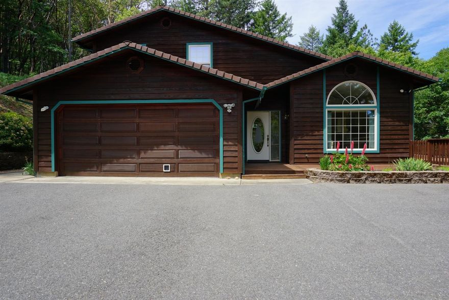 Beautiful woodsy home tucked back in a country cul-de-sac! Home has light and bright entry with wood flooring into a large kitchen with plenty of storage and sweet dining room with built-ins and sliding door to a nice deck. Nice flow into a large living room with fireplace and windows to let all the light in. The master is downstairs with private deck to the hot tub. There is another large bedroom downstairs along with a nice size laundry room. Two other bedrooms and another bathroom are upstairs. There is a detached shop down below the home, nice fenced yard, and beautiful landscaping. The property also backs to BLM! Come check out this country oasis before it's gone! All information is deemed reliable but not verified; anyone considering purchasing this property should perform their own investigation into the uses and condition of the property.