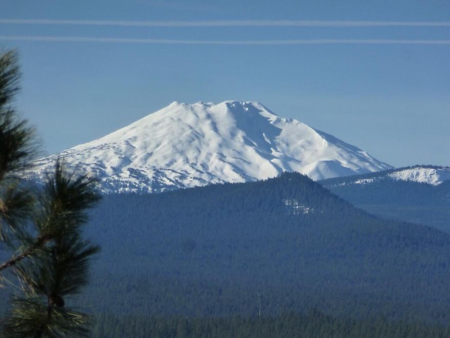 Welcome home to this west hills gem!  Enjoy views from Mt. Bachelor to the Old Mill smokestacks!  This sunny, open floor plan has a kitchen with granite countertops, a new Bosch 5 burner gas stove, and a large island with seating.  The primary suite is on the main level with a spa like bathroom and deck access.  Downstairs you will find a large bonus room with access to the hot tub, two additional bedrooms, and an updated bathroom.  The 3 year old roof has PV solar panels that will keep your energy bills low!    A newer HVAC system with AC for the main floor and a new hot water heater take care of all the details making this home move in ready. Three outdoor decks make for great outdoor living spaces.  Don't miss the additional shop / storage space not included in the square footage. The West Hills on Bend's westside is a quiet neighborhood with restaurants and amenities only a few blocks away.