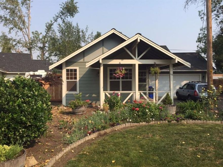 Charming craftsman style cottage sited near the end of the road with great privacy and easy access to downtown Talent. This completely flat lot has a fully fenced backyard with a brand new fence, garden, patio, grass for playing and a nice deck covered with an arbor creating a great entertaining space for outdoor dining. Inside the home, you will find vaulted ceilings in the living/dining area and master bedroom, upgraded faux wood window blinds, laminate wood floors in the main living area, a separate laundry room and an upgraded kitchen with matching appliances and ceramic tiled countertops. The yard is full of beautiful perennials including roses, wisteria, clematis and mature aspen, pine and mimosa trees. Enjoy many relaxing evenings from your covered front porch.