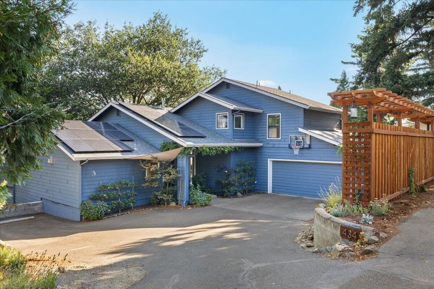 Sweeping views of Grizzly Peak and the stunning hillside from nearly every window, this upgraded gem offers luxury and comfort in every detail. Many new whole house upgrades inside and out. Vaulted ceilings, hardwood floors and a warming stone fireplace. The chef's kitchen boasts Viking appliances, granite counters, soft-close cabinetry, and an outdoor BBQ area. Main-level primary suite features fireplace, spa bath with steam shower, soaking tub, and heated floors and outdoor hot tub. Enjoy expansive decks, a new 6.8 kW grid-tied solar system, new HVAC, a lush 0.39-acre lot, fully fenced with lovely terraces, mature fruit trees, productive garden in the raised beds, and the potential for an ADU with private entrance. Finished garage with custom floor and storage. A truly exceptional Ashland retreat!