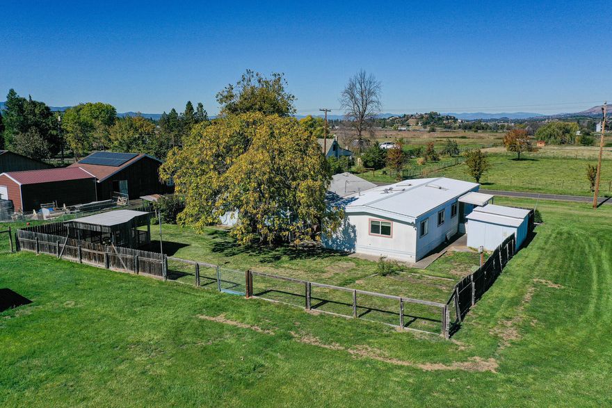 Nicely remodeled older mobile home on rural land between Phoenix and Talent!  This 1.65 acres is on nice flat land and has panoramic mountain views and is on TID irrigation.  Upgrades include new windows, newer furnace, air Conditioner, water heater, LVP flooring, remodeled bathrooms and hickory cabinets in the kitchen.  There is also an ADU that is attached to the 3 car garage which has it's own bathroom and additional living space.