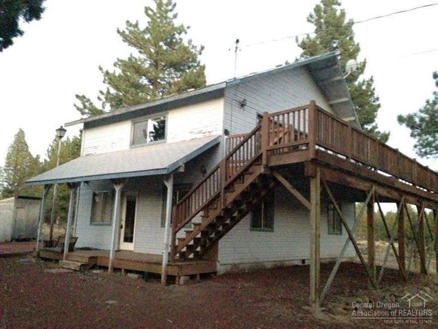 Come and get cozy with this cute two story country home in beautiful Sisters, Oregon and near Aspen Lakes Golf Course. Has a large country kitchen with tiled counter tops, second floor great room with large vaulted ceilings, windows and knotted pine accents throughout. Walk out to the huge second floor deck to take in the views of your ponderosa treed 5 acres with space to spread your wings!