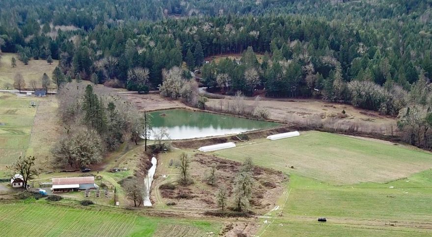 23.96 acres zoned Farm Resource, Irrigation Rights dated 1922 from Madams Creek, 4.5 acre Reservoir, Farm House & Multiple Outbuildings to Offer. Potential for future agricultural farming, livestock grazing, vineyard or your future dream home. Early 1900's farmhouse updated in 2016. Updates include, flooring, paint, appliances and multiple mini split HVAC systems. Domestic well to serve main home and a new 2nd well (60gpm per well log) for potential new homesite. Additional outbuildings include milk barn, hay barn w/new concrete floor & work shop, equipment shed and detached 2 car garage with carport. Located 11 miles from central Grants Pass & 2 mins from the famous Finley bend fishing hole across from Matson Park. Owner carry terms available to qualified buyer. All information deemed reliable, but not guaranteed. Anyone considering purchasing this property should perform their own investigation into the uses and condition of the property.