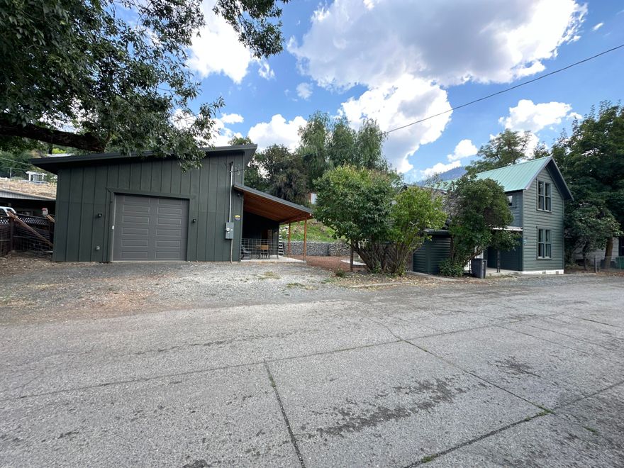 This charming two-story contemporary home built in 1910 boasts numerous updates and is full of character. With 1,272 square feet of living space, it features two bedrooms and one bathroom. The property has been enhanced with new wiring and plumbing, and the kitchen has been modernized with Ikea cabinets. Additionally, it showcases attractive laminate flooring and new Low-E windows.In 2023, the seller constructed a new shop, which includes a concrete floor, plumbing for radiant floor heating, insulation, and a loft for additional storage. The workshop is equipped with 220 power and features a finished room with heat, making it ideal for use as an office or guest space. The electrical service to the workshop has been newly installed and runs underground to the home. A sauna sets up on the hill with a woodstove overlooking the home, a really cool addition to this property. Commercially zoned allowing you to run your business from home. Own one of Canyon City's original homes.