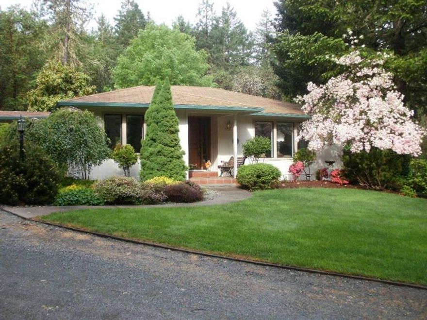 Beautiful custom home on over 5 acres. Lovely home has 2 bedrooms/baths, living room, formal dining, eat-in island kitchen & small office on main level; family room, 3rd bedroom/bath, 2-car attached garage & shop area in daylight basement. Amenities include granite counters, hardwood/laminate flooring, wet bar, wood stove, pantry, breakfast nook, bay window, skylites, ceiling fans, private master balcony & spa-style master bath w/soaking tub & separate shower. Newer Trex deck sets off the hot tub. New HP system installed this past winter. Also has detached 2-car garage, 2-stall barn, storage shed, wood shed & RV pad (former hardship setting) w/water, electricity & its own septic. Existing VA loan is assumable for qualified buyer.