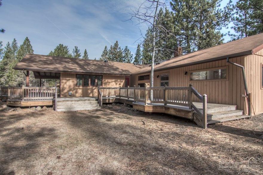 What a location! Just over one acre tucked in among the pines bordering National Forest. Spacious single story with an open floor plan and two master suites, would be ideal for extended family. Two offices/bonus rooms and an additional bedroom, or add a closet for more bedroom space! Entertain on expansive decking, both covered and open for your outdoor enjoyment. Just minutes from downtown Sisters.