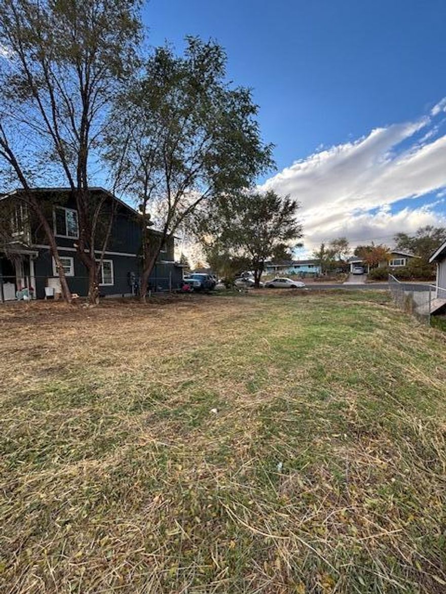 Ready-to-build lot is a very rare find! Location, close to school, restaurants, jobs, medical, park, makes it even more appealing.  Fairly level lot is very versatile with R2 zoning, which can make it eligible for higher density if desired!   The city water vaults are already situated on the lot, plus power and city sewer available by the street.  Situated on a paved street where the curbs are already in place.  The City of Madras says that a single family home, duplex, manufactured home, or possibly multi-family could be built here.  There appears to be single family home built on one side, and a duplex on the other. Helpful info is available from the City or Jefferson County.  Phone numbers, documents, are all available on the listing, just ask your agent.  Ideal land for investment, holding, or to build right away.  You will love this friendly convenient neighborhood location close to everything!  Get all your questions answered and schedule a private showing, Call now!