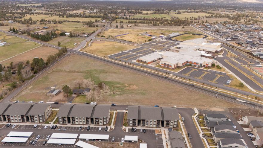 Beautiful mixed-use development in South Redmond. Surrounded by new residential development and across from the new Ridgeview High School. Close to the new Westmount mixed-use development which features Sunriver Brewing, Backporch Coffee, and Bonta Gelato. Flat topography with city water and sewer in adjacent streets. 1,950 SF house and outbuildings for current rental income.