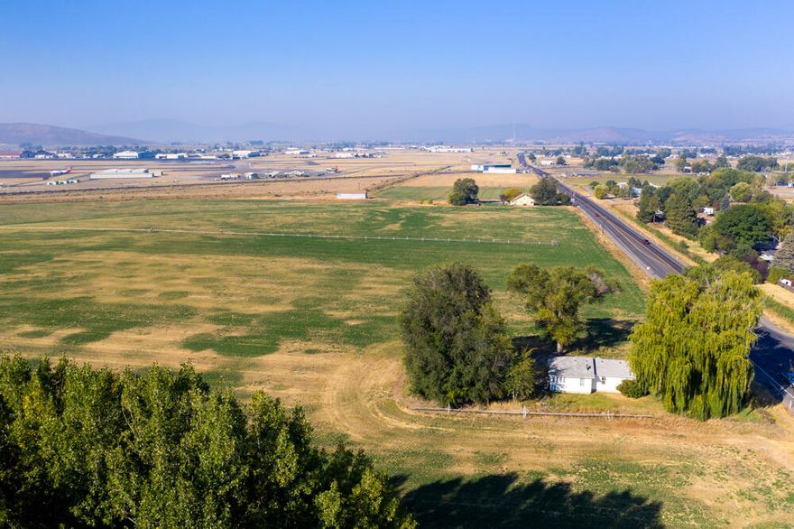 75.26 Acres Zoned Light Industrial. Access is now provided by road running East to West Coming Off Brett Way to Air Way Drive. Property has buried utilities, along with City water and City sewer. Geothermal Well tested at 1048 feet. Temp at 102 degrees.
Seller to provide Clear Phase 1
See Documents: For Maps, Geothermal Well Log. 
Contact Listing Agent for Phase One
Tenants are Month to Month. RSIS is officially  approved in the eyes of the state.