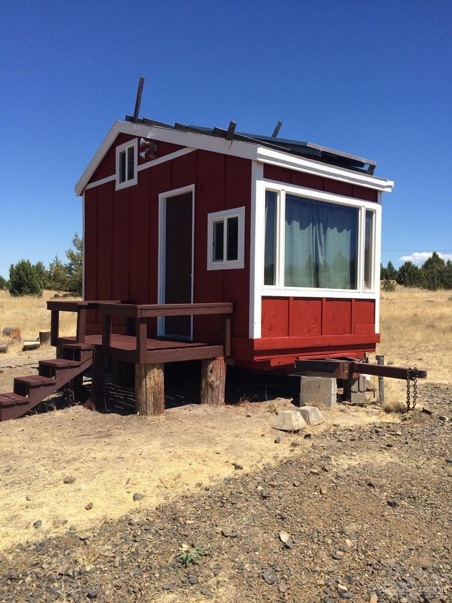 Incredible 360 degree views of Cascade Mountains, Gray Butte, Grizzly Mountain and other Landmarks. The Domestic Well works good using solar power from the small cabin. The cabin has sleeping space, kitchen area, couch, heater & a shower. Current Owner is building a nice porch, cutting branches & cleaning up the Property. The land has a gentle slope towards the Mountains, borders National Grass Land on the west, fenced on north & south, good grazing for critters & has a gated entrance & no near Neighbors!