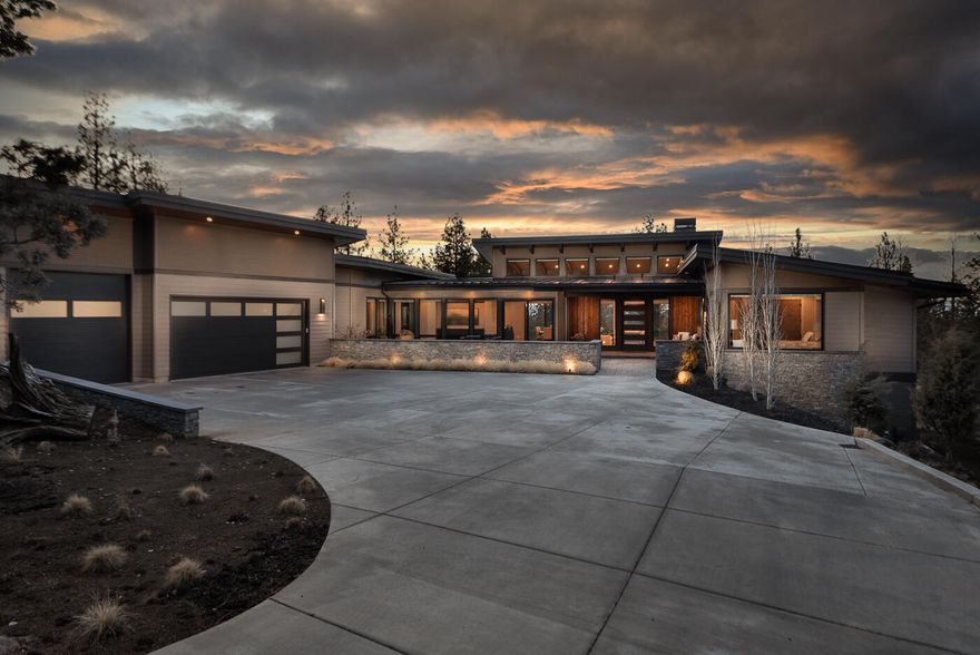 Custom NW contemporary home featuring high quality details throughout (see attached document). Single level open floor plan with walls of windows with abundant natural light. Vaulted ceilings, fireplace with floor to ceiling surround. Thermador appliances, Butler's pantry. Primary Suite with fireplace & patio access. Primary bath with curbless tile shower, soaking tub, radiant heat. Private guest suite with curbless tile shower & radiant heat. Third guest suite with courtyard access & Jack/Jill bath to bonus room. Office with built-ins. Laundry room with extra flex space. 1,057 sqft 3 car garage with oversized 3rd bay, windows, epoxy floors, built-ins, 2 separate 220 outlets. Covered patio with gas fireplace, built-in BBQ & TV. Courtyard with stone wall, water feature & pavers. Heated driveway from street to main double door garage. Home includes built-in frame TV's & speakers. Expansive storage area with concrete floor plus mechanical room for 3-zoned heating & tankless water heater.