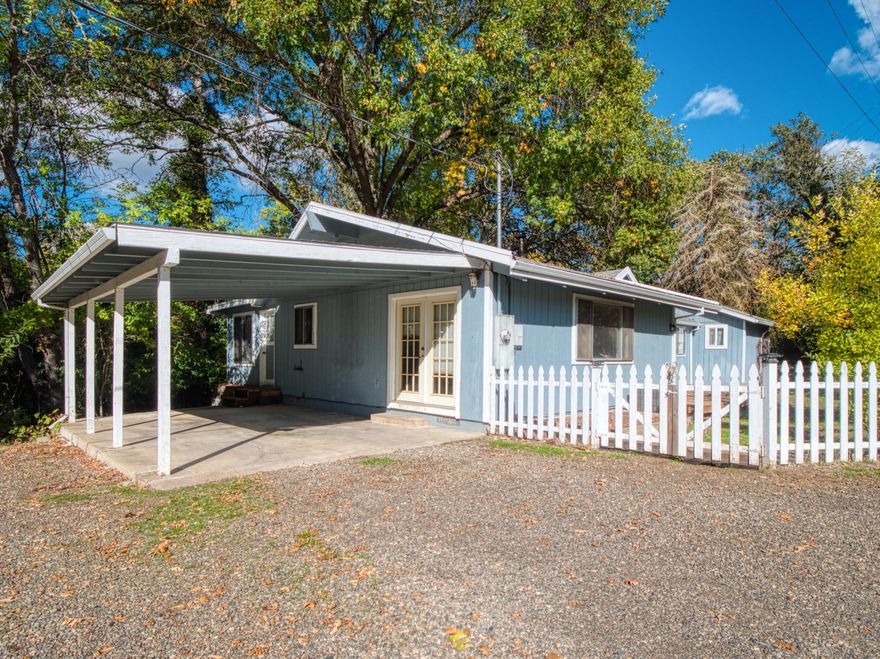 Park-like rural setting with a seasonal creek running through it! Rustic home with vaulted ceilings and exposed beams. Warm yourself with the wood stove and access the property with a footbridge across the creek. Detached garage and sheds for storage and plenty of RV parking!