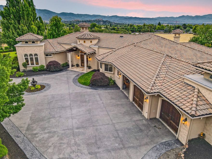 Premier, one level home with fantastic views and location.  This flat, useable one acre parcel has a private, rural setting and is only a mile from Asante Medical and the RVCC golf course.  Built by Mike Pagnini, this timeless Tuscan style home is an entertainer's dream.  Features include:  Gated, courtyard entrance.  Large, Island kitchen.  10-20 ft. high ceilings.  Hickory hardwood floors.  Built-in cabinetry.  Theatre room.  Temperature controlled wine room.  Beautiful wood work details including beams and columns.  1,700 sq.ft. of tiled, covered, patio space including a fireplace, built-in kitchen and outdoor TV screen.  Huge, level backyard with more than enough room for a pool and/or an accessory dwelling unit (ADU).  3 car, oversized garage with room for a golf cart.  Stunning master suite with exercise room/office, fireplace and luxurious master bath.  Gorgeous views of the valley and mountains.  Tile roof, wrought iron fencing and plenty of parking space.  Room for RV parking.