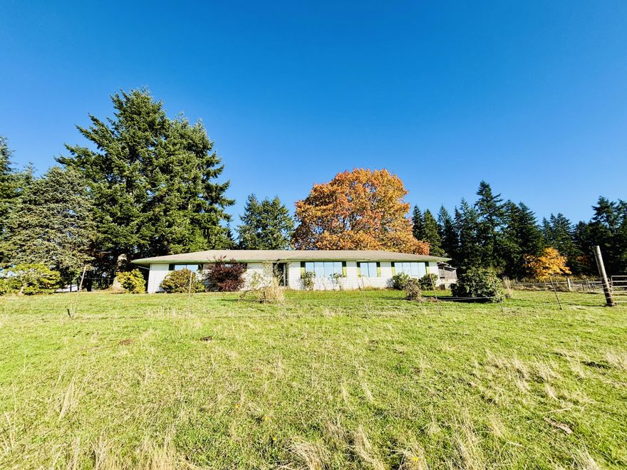 Private 20-acre hilltop ranch in rural Clackamas County, set at the quiet end of a dead-end road with sweeping valley views and exceptional privacy. This single-level 3-bed, 2.5-bath ranch home (approx. 2,428 sq ft, built 1973) sits on gently rolling terrain featuring open pasture, 5+ acres of mixed forest, and established apple trees. Multiple outbuildings include a concrete-floor shop, horse barn, and detached garage—ready for your improvements and personal touches. The property backs to timberland with access to local riding and hiking trails (buyer to verify). Estate sale; property sold strictly as-is, where-is, with all items conveying. Buyer to perform all due diligence. Sale subject to Clackamas County Probate Court approval.