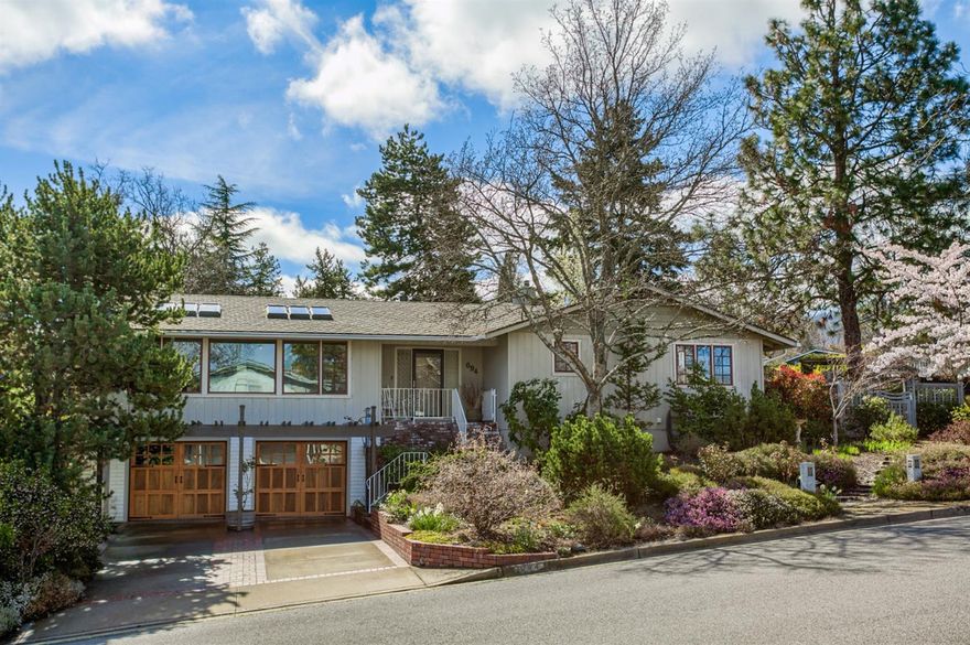 Beautifully situated 2,000 SF home atop Oak Knoll w/fabulous views. Updated by professional architect featuring 6 large, operable sky-lights & custom details. These attributes along with a cozy gas fireplace & wonderful mountain views, commingle effortlessly to create a serene, inviting home. The updated dining/kitchen area has great storage & spectacular indoor/outdoor feel as you enjoy meals looking out upon the gorgeous gardens. Each bedroom has its own exterior access, wonderful natural light & lots of flexible space. Indoor laundry, multi-zone indoor/outdoor speaker system, hardwood & tile flooring & ample storage throughout. Updated Pella French doors along the back of the home open up to a large deck where you can enjoy the professionally designed, year-round gardens featuring an exquisite water feature/pond, centuries-old oaks, flowering & fruit trees & much more!