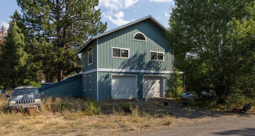 Finally - a well-priced fixer in La Pine, ready for your vision! This 3-bed, 2-bath home offers 2,052 sq. ft. of potential on a level, treed 1-acre lot. Built in 1977, it's a rare opportunity to personalize your own home. The main level features 2 beds, 1 bath, and a utility room with a sink. Upstairs, enjoy a private primary suite with vaulted wood-accent ceilings, soaker tub, bonus/office/craft area with built-ins, utility sink, propane heat, and access to a covered deck. The living/dining area has a cozy certified wood stove, ceiling fan, and French doors to the backyard, while the galley kitchen offers abundant wood cabinetry, pantry storage, and hardwood floors. Property highlights include a covered front porch, 2-car garage with built-ins, metal roof, RV/boat parking, two sheds (one with power/heat), private well and septic. With no HOA and close to Hwy 97, shopping, dining, lakes, rivers, Mt. Bachelor, Sunriver, and Bend—this is your chance to build equity and make it your own.