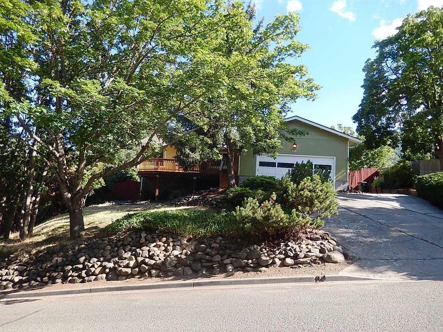 Located high above the Boulevard with great views of Ashland & the East Hills. Lovely 3 bed, 2 bath home is immaculate & move-in ready. Beautiful hardwood flooring in the Kitchen & Informal Dining. Lots of windows make this home light, bright & inviting. Large Master Suite with walk-in closet & attached bath. Big Dining Room with slider that leads to a beautiful covered Deck with graceful Wisteria Arbor & privacy-fenced yard. Raised Garden beds and a multitude of flowering bulbs & wild flowers make this yard an enchanting place to relax. There's also producing Plum & Apple trees. Sellers have installed new baseboard. Kitchen cabinets have been refurbished with new hardware. New Exterior Paint. Big newer front deck provides additional peaceful views. Over-sized attached garage offers lots of storage & shelving. Additional storage under the house in the dry partial basement accessed from exterior. For the hiking enthusiasts, Ditch Trail and Lithia Park are close by & easily accessed.