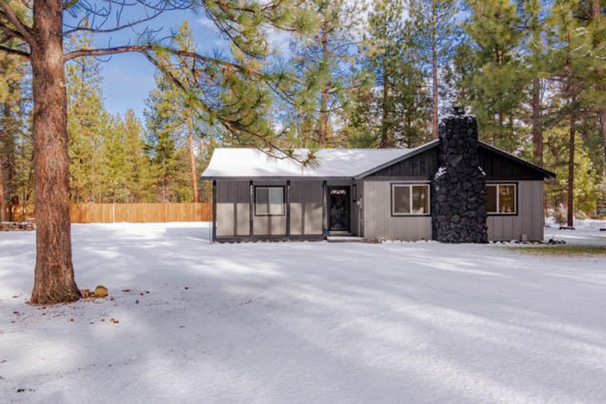 Inside this lovely little beauty is the definition of cozy Americana.  This home exudes ''home sweet home'' appeal with features such as rustic barn doors, exposed beams, black stone fireplace with brand new free standing wood stove, farmhouse sink, butcher block kitchen countertop with mason jar light fixture, tongue and groove wood accent walls, and new low maintenance flooring in the living room and kitchen.  The home sits on a nicely manicured lot and has a new roof, septic, carpet, siding, ductless heat & AC, windows, and new Samsung appliances. Outside, there is plenty of room for parking, and a large stamped rear patio.  Neighborhood amenities include tennis court, basketball court, clubhouse, and pool.  Property backs to national forest land.