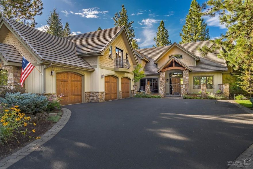 Nestled amongst the pine trees along Broken Top's 7th Fairway, sits this magnificent mountain lodge home. Vaulted & timbered ceilings, wood wrapped windows, massive wood burning fireplace in the great room creates a relaxing space for entertaining or quiet evenings at home. Expansive, golf course view, kitchen includes granite slab island, walk-in pantry, breakfast bar & dining nook with views of back yard landscape. Entertain in style in elegant dining room w/ adjacent wine cellar. Main level master suite offers fireplace, golf course view patio, spacious bath w/ free standing tub, separate vanities, walk-in closet & private patio w/ hot-tub. Wood paneled office is also located on the main level. Home offers plenty of room for family & guests in 2 charming en-suite guest rooms, loft area sitting room & family/media room. Outdoor living area features stone fire-place, built-in BBQ & large paver patio overlooking the golf course, as well as front courtyard w/peaceful water feature.