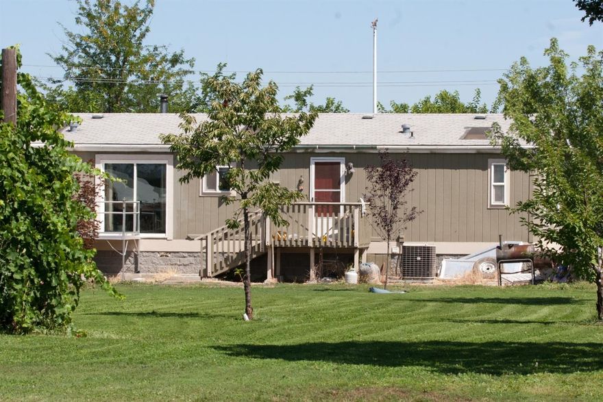 Close in, irrigated horse setup in the CP2 Urbar Growth Boundary., featuring comfortable 1512 sf 3bedroom, 2 bath manufactured home, 4 stall mare motel with paddocks, large barn, 3 stall open shedrow, turf riding arena, pond, pasture, chicken house, shop, carport, outbuildings, and original farmhouse (used for storage and to reserve building site for future garage). Now is the time to enjoy harvesting the many bearing fruit trees and grape vines. Don't miss this diamond in the rough. Buyer and Buyer's Agent is to verify ALL information.