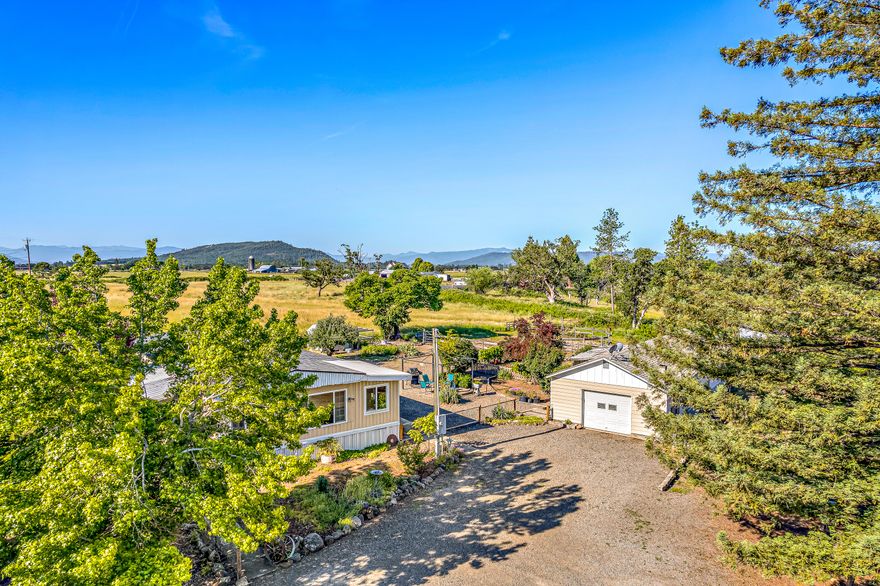 Welcome to our little farm. Enjoy beautiful views overlooking Reese Creek and farm land. This 5.99 acre lot is fully irrigated and has a producing hay field. The land is fenced and cross fenced for easy rotation of livestock. Great homesteading opportunity. The land has a 3.5 gal/min tested well, newer inspected septic system, Rv hook ups, shop and hay barn with a stall and storage. Property can easily sustain cattle, horses, goats, chickens and pigs with little need for external food sources. The yard has fruit trees, grapes, garden areas, chicken coop and duck enclosure. The fields are lined with berry bushes that generally produce over 300 gallons of blackberries a year that make excellent jams, jellies. 5 generations of family have lived on this property for over 80 years. 10 min away from schools, shopping, entertainment and the Rogue River. This is your opportunity to truly live off the land you own and control your food source.