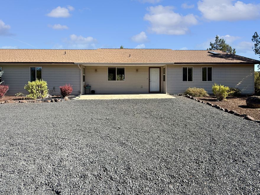 Nestled on 4.55 acres in Prineville, this single-level stick-built home combines comfort, functionality, and wide-open views. A two-car attached garage is complemented by a detached, permitted two-bay shop complete with loft storage, offering plenty of space for hobbies, projects, and toys. Approximately two acres are fully fenced with a secure electronic gate and code entry for peace of mind, while an additional fenced garden area is ready for your green thumb. Enjoy evenings on the back patio overlooking panoramic views and take advantage of the privacy and room to roam this property provides. With the perfect balance of shop space, acreage, and stunning scenery, this home is ready to welcome its next owner.