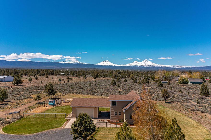 Nine Peak Cascade Mountain Views in this beautiful 3 bed / 2.5 bath chalet style home on 10 acres. Vaulted 23 ft cedar ceiling and open layout with updated flooring, propane fireplace w/ lava rock surround and built in speakers in the great room. Primary suite on the second level with walk in closet, loft storage and attached bath. Additional bedrooms on main, one with attached bath and slider to outside deck. Large utility room and powder bath off breezeway entry. Oversized 2 car garage, 32x48 shop with 2 oversized RV garage doors, insulated and heated workshop space in the rear of the shop w/ interior garage rollup door with airlines piped through workshop and air pressure tank in main shop. RV power hook up on the side of the shop with a 20amp breaker. Chicken coop and raised garden beds with drip system and frost free spigots throughout the property. Two pastures with 12x12 and 12x24 Noble shelters. Fryrear Canyon riding trails nearby.