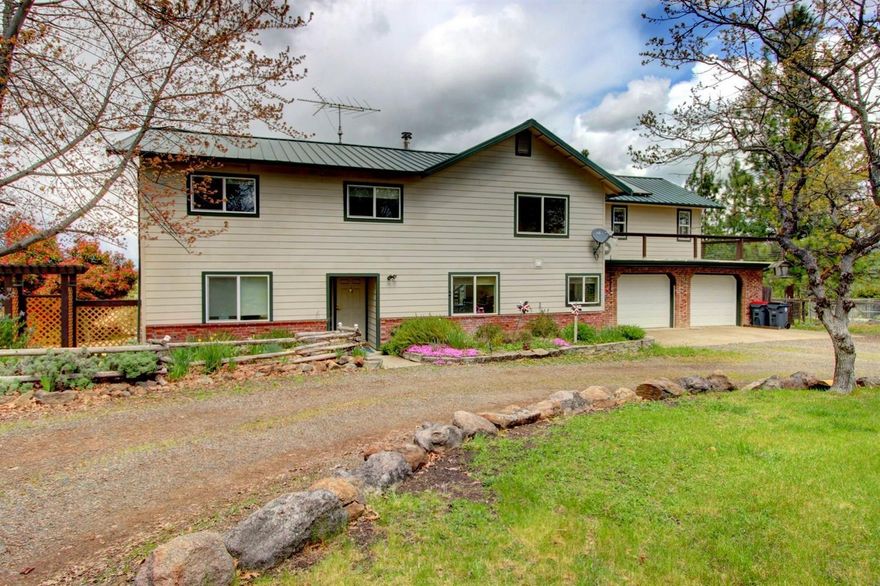 Make this beautiful 26 acre hilltop equestrian retreat with amazing Agate Lake views your new home! The 2,784 sq ft home features soaring vaulted ceilings, an open floorplan, and captivating views from nearly every room. The large master suite features a beautiful vaulted ceiling, recently remodeled bathroom, walk-in closet, and wonderful wrap around balcony. Three additional bedrooms, a loft, and a spacious bathroom are upstairs and you'll find a private office and family room downstairs. This home is made for entertaining with large open spaces and access to the large deck that overlooks the property, mountains, and Agate Lake. This is a great horse or 4-H property with cross fencing, a lighted 120x65 riding arena, stables, a round pen, and huge 40x60 shop that has full power, a/c, a loft and two separate rooms. There is a circle drive, plenty of parking for friends and family, and even RV hook-ups. Come see this great property today! 1-year home warranty provided to buyer.