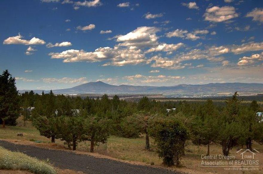 Incredible views from this 1.84 acre rural property. Immaculate, spacious 3bd, 2.5ba, 1902sf mfg home with living room, family room, kitchen nook + formal dining room. Enclosed breeze way/ mudroom/ storage room with easy access from double attached garage. Lovely enclosed sun room with insect free screens overlooks the Prineville valley. Nicely landscaped - large RV shed + additional areas for RV parking and complete RV hookup. Don't miss this one.