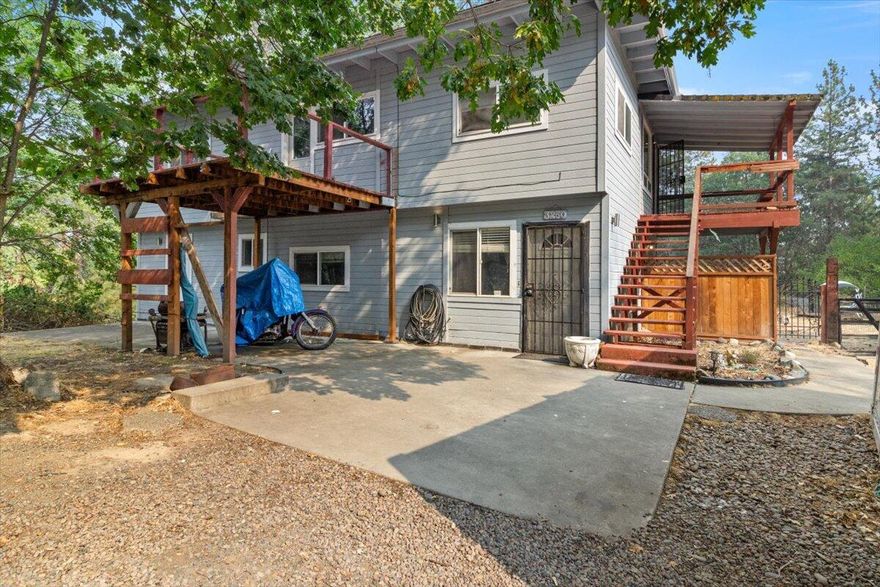 Come experience this peaceful 2.26-acre setting, nestled among the trees in North Grants Pass. This home is 2150+ sq./ft and set far back from the road with plenty of privacy. Convenient circular drive in place and there are multiple flat pads around the home for everyday recreation or entertaining guests. Although this home is priced as a 2-bedroom, it functions comfortably as a 4-bedroom home and offers an exceptional value in today's market. With dedicated exterior access to the top level, this home could also serve as an extended-family or two-family set up. Property also includes multiple decks and an outbuilding currently used as an art studio. Appointment Only. Please call your broker to arrange your private showing today!