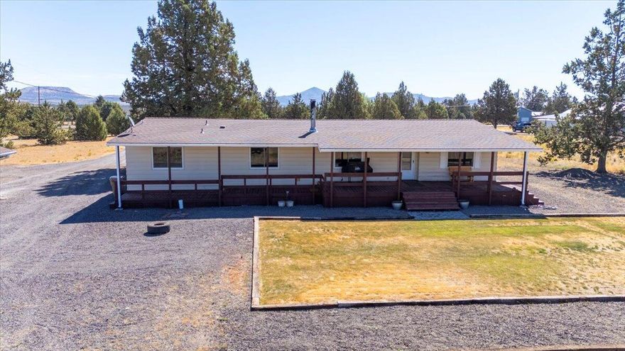 Move-in ready manufactured home on just under 2 acres in Crooked River Ranch! This property features new luxury vinyl plank flooring, fresh interior paint, 4 bedrooms, 2 full baths, fully finished detached 2 car garage, and a roof that's less than 10 years old. Stay comfortable year-round with a serviced heat pump and cozy wood stove. Enjoy the peaceful setting from decks, all set back from a paved road for added privacy. Located near the fire department for peace of mind and quick access. A great opportunity to own in a scenic and well-established community!