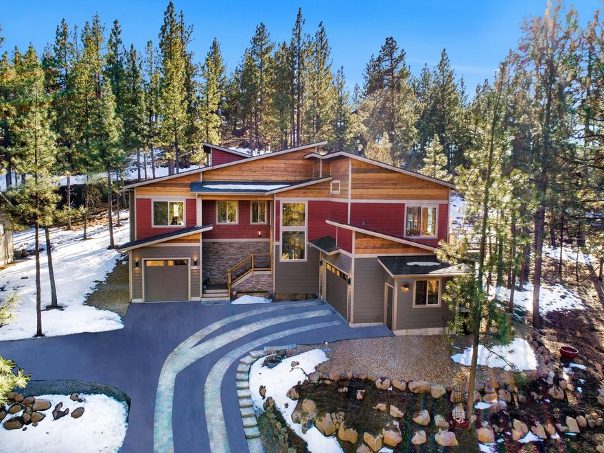 This less than a year old, Awbrey Butte home is a stunning example of mountain modern. It represents timeless design and finishes, creating a feeling of pure aesthetic pleasure. With abundant natural light and views of towering pines, the interior setting is nothing short of breathtaking. The finishes throughout are remarkable and include an old growth black walnut island countertop, an authentic reclaimed mantel from Fort Clatsop, solid hickory floors, wood doors and trim and barn-wood accents. The kitchen is an all out show stopper with its custom cabinets, granite countertops, commercial grade appliances and a complete butlers kitchen. The three car garage is over 1,400 sf in total and features a shop, dog washing station, gear garage and an expansive storage area. If that's not enough there is also a heated driveway, hot tub, sauna, a large deck for entertaining and no HOA fees!