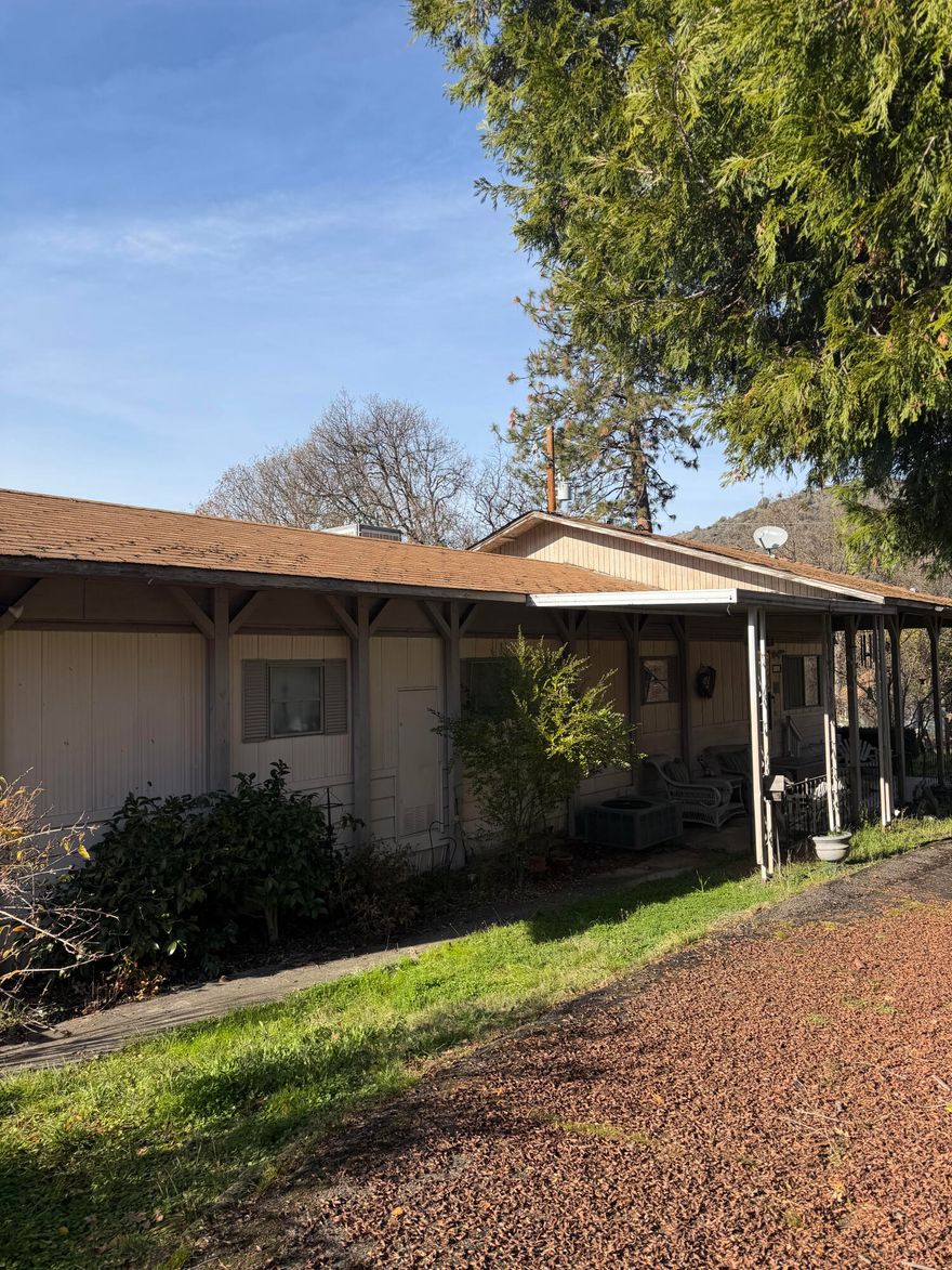 This is a wonderful opportunity to own a private sanctuary so close to town! It is a beautiful property with two homes on it, with two wells, and lots of storage. The first home is a manufactured home, built in 1978, with a newer addition to the living room, and an extra -large kitchen.  The second home is a one bedroom, one bath cabin, with cedar siding, propane heat, and metal roof.  There are 5 outbuildings and small animal stable - perfect for 4-H and family projects.  The pasture is beautiful, and the location is great.  A must-see property!