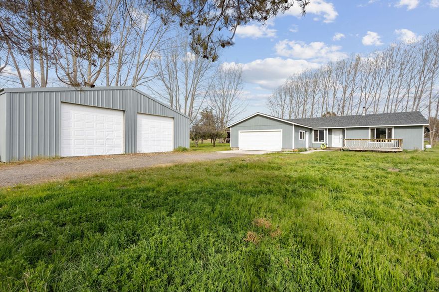 Welcome home to this large, single level, 3 bedroom, 2 bath home on almost 5 acres. Built in 2001, this is 1,792 sq ft open concept with large great room w/wood stove (installed in 2018) for efficient heating. There is also a heat pump & A/C. Kitchen includes all appliances and has a breakfast bar & pantry. Three large bedrooms with accessible features in the primary. Property has a 2 car garage + a 36x40 shop w/electricity and wood stove. The property is lush and green with large mature trees,  partially fenced and would be perfect for horses or cattle. Located on a quiet cul-de-sac off of Davis Loop. Property has shared well for domestic use and has a 2nd private well for watering or animals. Don't miss your chance to have your own piece of land with a large, well cared for home. Call today for your private showing.