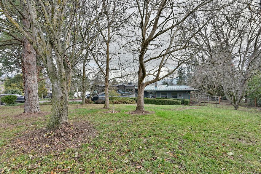 Beautiful Mid Century Modern home on huge one acre lot in very desirable area of Ashland. Mature trees throughout this property including several fruit trees, grapes, and berries. Large garden area and room to expand and grow. Separate Garage/Shop and plenty of area for RV parking. With 3325sqft of living space, 4 bedrooms, and 2.5 baths, there is plenty of room for large families, as well as possible 2 family set up with separate entrance. Beautiful Valley Views, large kitchen with tons of storage, Newly renovated Master bath. This Home has everything you have been looking for.