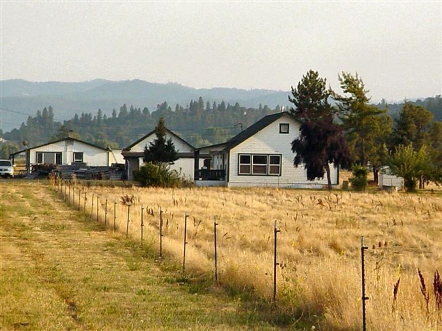 Two dwellings, this property has it all! 360-Degree views of Table Rocks. Mt. Ashland & surrounding mountains. Property also has irrigation rights. The two dwellings are on post & pier only, so may be some work for financing. Possible for bare land loan or owner carry. The homes are older, but very livable with little fixing to move in. Walls are tongue & groove. Main home is 1,120 sq.ft., 3-bedroom/1-bathroom. Second home is approx. 850 sq.ft., 1-bedroom/1-bathroom with extra office the size of a bedroom. Nice kitchens in both with big pantry in main house. 8-year old roof on main house. There is one well & two septics on this property. Separate gas meters & combined electric. Very large acreage surrounds this parcel for privacy & tranquility. These homes sit way off road. No noise. This is a gold mine. Owner has not irrigated this year. Buyer to do their own due diligence in legality of both homes.