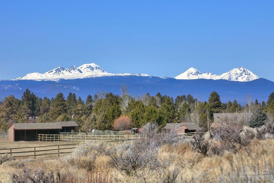 This incredible gated Country Estate property has it all! Boasting panoramic views of the Cascade Mountains & Ochocos. Enjoy the spacious living room with a propane fireplace, gourmet kitchen, Family room, Media room, Formal Dining & Office. Beautifully landscaped yard with a tiered cascading waterfall. Detached apartment cottage with large living area, bedroom and full bath. 1,200 sq. ft. heated workshop with 10' ceilings & roll-up doors. RV parking w/power. Boat, swim or fish for bass in the pond. Enjoy hiking/biking trails. Fenced 9 acre pasture with underground automatic irrigation.<br>
