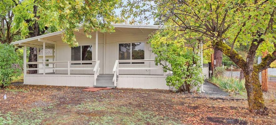 Seller Financing Available! Freshly updated and move-in ready! Charming 2-bed, 1-bath manufactured home on an appealing quarter-acre. Skip the bank hassle—this seller carry option gives qualified buyers the chance to secure a home with straightforward terms and a predictable monthly payment. Minimum Down Payment: $30,000. Enjoy new luxury vinyl plank flooring, fresh exterior paint on the home, deck and garage, new mirrored wardrobe doors, and a fully remodeled bathroom and kitchen with new countertops, fixtures, and backsplash. Major systems have been modernized: septic tank and drain field (2014), well pump (2018), new central heating and air conditioning system (2025), and all-new electrical service panel and wiring to home, garage, and well (2025). The 16'x20' garage (built 2021) features new wiring and door opener. Additional perks include a new pump house (2025), upgraded sprinkler system with new backflow prevention device (2025). A rare blend of comfort, efficiency, and value!