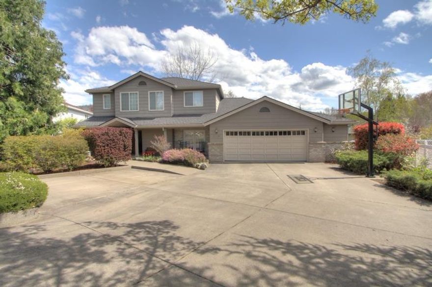 This is the first time on the market for this super nice custom built home in the sought-after Lone Pine School District. The well thought out design has been graced w/a large, updated island kitchen w/slab granite counters, abundance of cabinets, & built-in buffet. There's a family room & breakfast area w/French doors to the patio. There's also a formal dining room & living rm w/ fireplace, built-in shelving, & French doors to the patio. A huge benefit is the handicapped suite at one end of the home! This features a large private living space, bathrm w/roll-in shower, walk-in closet, & French door to the patio. Plus, there is a bedrm & full bath across the hall. This can all be accessed either by a separate outside entrance, or a hallway to the kitchen. The additional bedrms, bathrm, & master suite are located on the upper level of the home. The 3342 sq ft home sits on a street with other beautiful homes, and has a huge driveway w/extra parking, & oversized garage w/shop area.