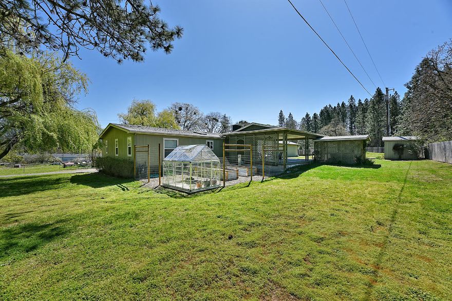 Country Living at its finest, but only minutes to town! This immaculate 3 bed, 2 bath manufactured DW home has been completely updated & on one acre!   Updated w/ many upgrades which include granite countertops in kitchen w/ island, custom cabinetry, can lighting & all appliances are included. Open living area w/hardwood flooring, gas fireplace & front deck. Lg bedroom suite w/custom tile shower, double sink vanity & huge walk-in closet. A detached 40 X 50 shop w/HVAC system, plenty of storage space w/ loft areas above. A 21x30 stamped concrete patio w/private hot tub, perfect for entertaining! Greenhouse & raised garden beds. New Heat Pump in 2013, New Roof in 2012 and On Demand Gas Water Heater in 2015 This property is in beautiful rural Grants Pass, with abundant wildlife, trees & nature.  Welcome home to your Pacific Northwest dream property!