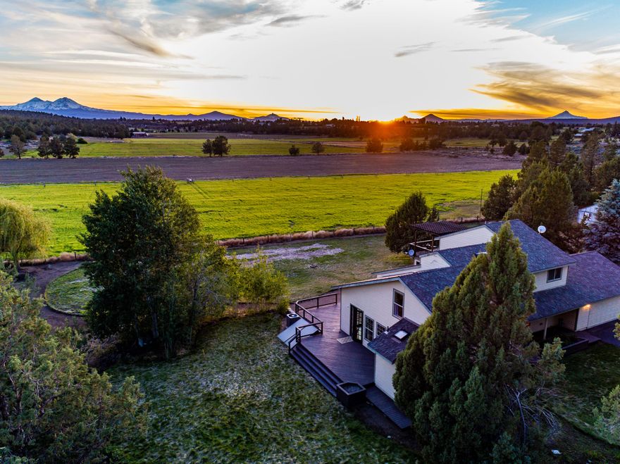 This lovely home sits on 10 beautiful Acres, with stunning Cascade Mt. views. Location is perfectly placed between Bend and Redmond. Private road takes you to a gated entrance, as you enter the property you will find a large pond on the left and a 4490 sqft, heated shop to your right, w/ 1300 sqft of covered RV parking. The home sits further back in a lovely, manicured park like setting w/ big mountain views from inside the home. Nice floorplan w/ one bedroom located on the main floor, and an additional two bedrooms and loft located on the second level. In 2019, a mother-in-law quarters was added that can be used as a master bedroom, guest room or possible office or studio. 9 Acres of irrigation rights come with this property along w/ 7 Acres of fields. Water system consists of a Well, Cistern w/ 2 pumps, a Pond and the Canal runs along the east side of the property. Property could be converted to a beautiful horse property. Please view VIDEO of this amazing property!
