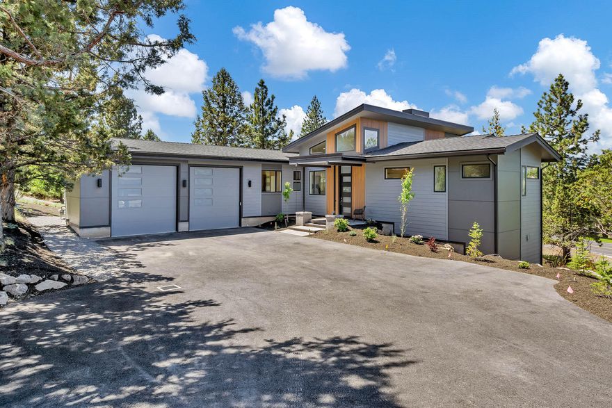 Enjoy Cascade Mountain Views from this new contemporary style home built by Hackbarth Builders, Inc. Outdoor enthusiasts will love the convenient location on Awbrey Butte as well as double RV height doors on the oversized garage. The master suite sits on the main level and features double vanity, tiled shower, soaking tub, and spacious walk in closet. Light and bright kitchen to include solid surface counter tops and stainless steel appliances. From the open great room access the elevated, covered deck to enjoy the privacy of your 28,000 square foot lot. Downstairs, your guests will love the separation of a second full bath and spacious bedroom in addition to the almost 350 square foot bonus room. Landscaping and AC included.