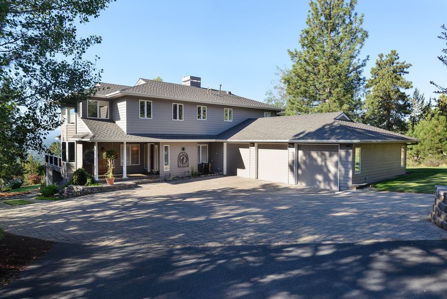 Privacy abounds in this gorgeous NW Bend Home perched on over 1 acre on the hill. The well appointed features present a warm, inviting, partially updated home with a well designed kitchen with butler pantry is open to the dining room and great room with built ins, a gas fireplace and abundant windows brining in sunlight and  views. The main level features plenty of room for entertaining, both kitchen area dining, a formal dining room and an office/den. Take in the south views while enjoying your morning coffee on the huge deck. An O/S 3 car garage is attached to main level. Upstairs is the Primary bedroom, 2 baths and two other bedrooms. Downstairs is a 4th bedroom, bath and access to an O/S one car garage and shop and also a wine tasting room and locked fireproof closet. This home and property have character and so much to offer. Lots of room to garden.