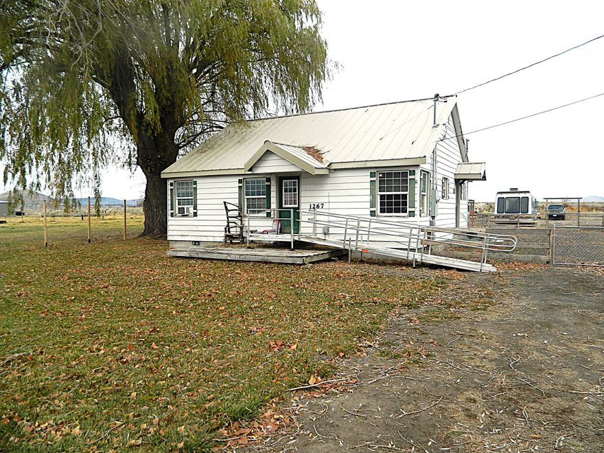 What a great starter home for the one that wants some animals. This 2 bedroom one bath home sits on 6.55 acres with KID water rights. The property has great pasture ground and is fenced and cross fenced. There is a chicken coop and small barn for storage or turn it into an animal shelter or a little bit of both. This property is within minutes to town so no long drives to get to your favorite shopping area. The home lives very comfortable with a good-sized living room and a separate laundry room. Both bedrooms are large enough to host a queen bed. All Henley schools as well. There has been a new well and pressure tank installed recently