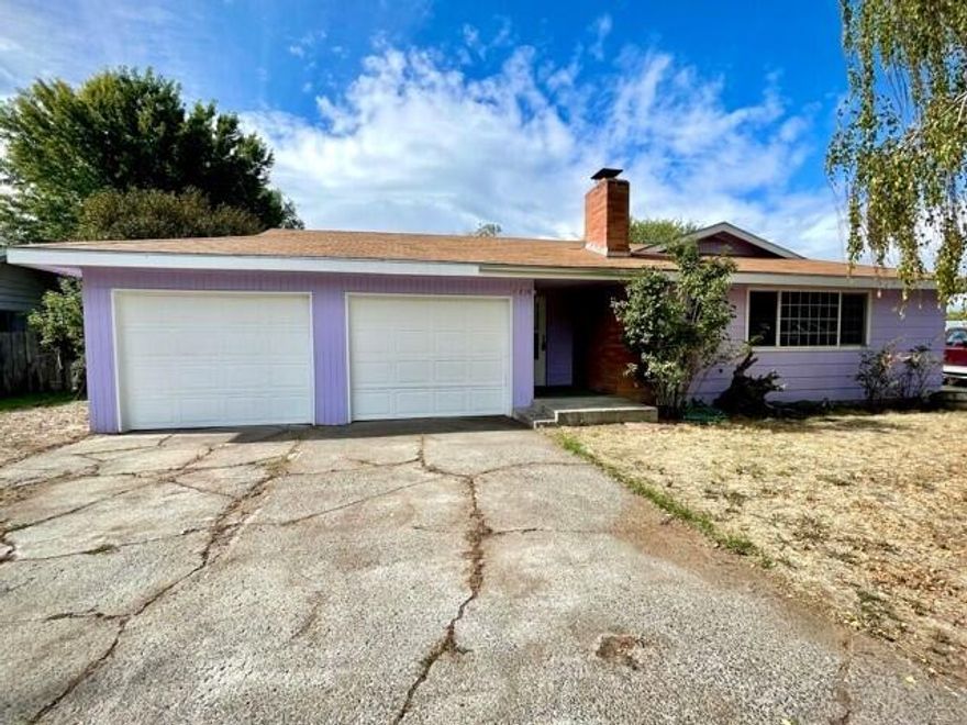 Cute home in the suburbs with great potential to make it your own! Featuring 3 bedrooms, 2 bathrooms, just shy of 1500 sqft, and situated on a large lot. Bright living room with rustic wood paneling and newer vinyl windows. Updated kitchen with wood cabinetry, garden window, laminate counters and open to the dining room with efficient certified wood stove in addition to the gas forced air heat. Covered patio off the kitchen with second slider off the primary suit overlooking the fenced yard with mature trees, and a clean slate so bring your landscape ideas. Attached 2 car garage with workshop space, and RV parking on the side.