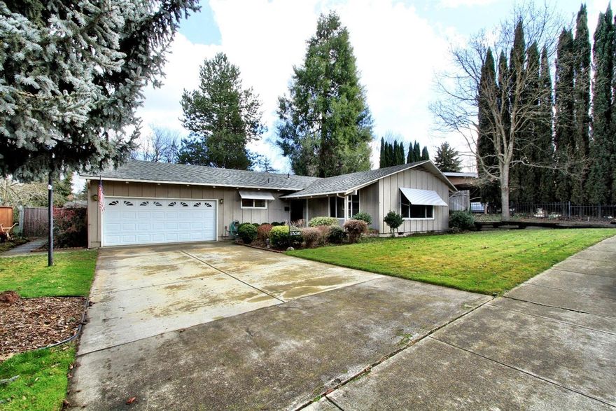 Charming single level home in a very desirable E Medford neighborhood, centrally located near shopping, schools and medical! The large fenced lot is beautifully landscaped with mature trees, plantings, large covered patio w/hot tub and decking, 3 bedroom, 2 bath home is turn-key, move-in ready. Upgrades include new custom tile shower in master bath, newer gas furnace, upgraded laminate flooring in kitchen, dining/family room & hallway. LR has fireplace w/mantle, large windows to enjoy the beautiful front yard. This is a very functional floor plan and flows well.