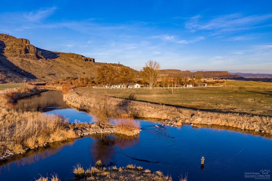This ranch is conveniently located between Redmond & Prineville and features 3,500ft (+/-) of Crooked River frontage. Historically operated as a cattle ranch. The river provides the avid outdoorsman with great fly fishing for trout, including the sought after Redband. The home features a timeless single level open floor plan. The great room is spacious with fireplace, vaulted ceilings, wood beams & great views. The charming open kitchen has a large peninsula & w/ample storage. The sprawling covered patio with sauna takes in great views of the Cascade Mountains. The mature trees & lawns make outdoor activities a delight. Just a few yards beyond the backyard is the River. The home has been well maintained & has a recently updated lifetime roof. Circular driveway with cattle guard, insulated shop & three covered bays for equipment & RV pad with full hookups. Irrigation rights from the Crooked River offer 90 (+/-) acres. The ranch is fenced & cross fenced for rotating 50+ pair of cattle.
