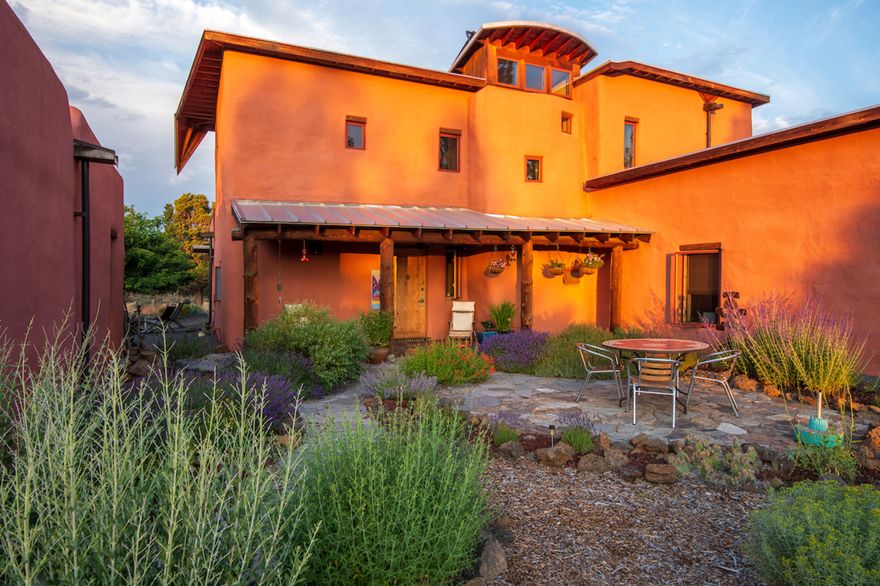 This Santa Fe style home sits on 40 acres of pristine high desert land. It borders National Forest with views of Mount Bachelor and the Three Sisters. Wildlife is abundant, and the property has old-growth juniper and ponderosa pines. Straw-bale construction offers amazing insulation properties year-round, easily warmed in winter with a masonry heater and radiant heated floors, and equally easy to keep cool in summer. Other features include: Saltillo tiles in living room; hardwood bookshelves in the study; south-facing windows for solar gain in the winter and light in the summer; light-filled staircase; two garages; greenhouse and more. The large solar array and batteries easily run 2 heat pumps in summer, if needed. Secluded and quiet, yet just 15 minutes from downtown Bend, this home offers a safe refuge from the uncertainties of today's world in a beautiful and natural setting.